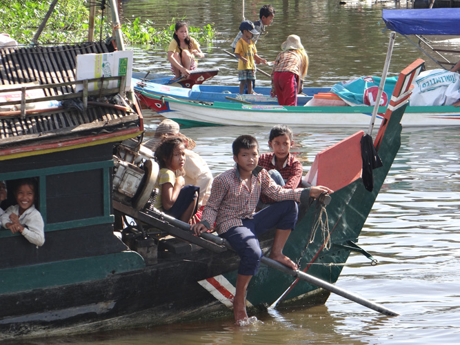 At one point our boat stopped for a break and two boats filled with Cambodians came up. Both of their boats were packed.